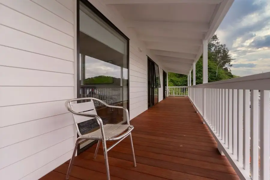White weatherboard wall and verandah with a timber deck