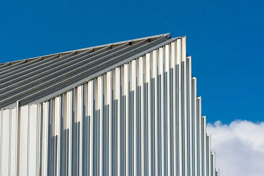 Corrugated steel roof edge against a blue sky